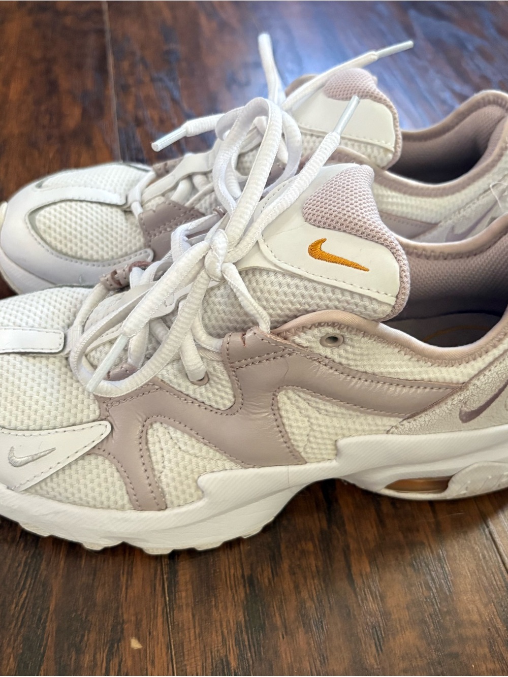 Nike Women’s White & Light Pink Sneakers with Gold Swoosh Accent